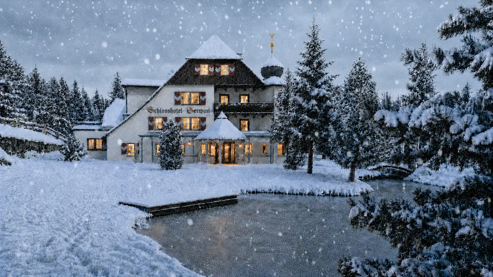 Schlosshotel Seewirt za sněžení s rozsvícenými okny
